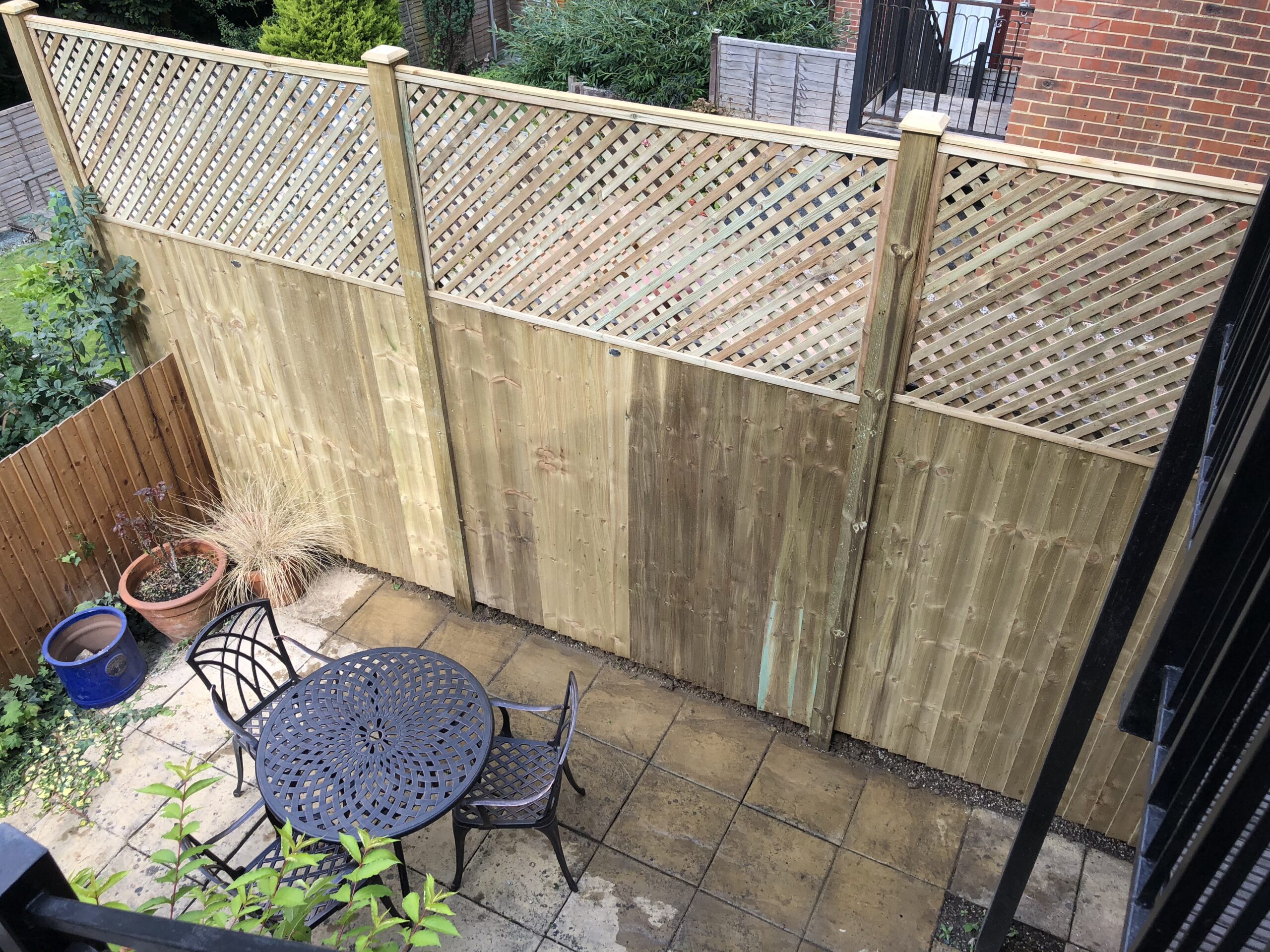 closeboard panels with privacy trellis and timber posts and post caps