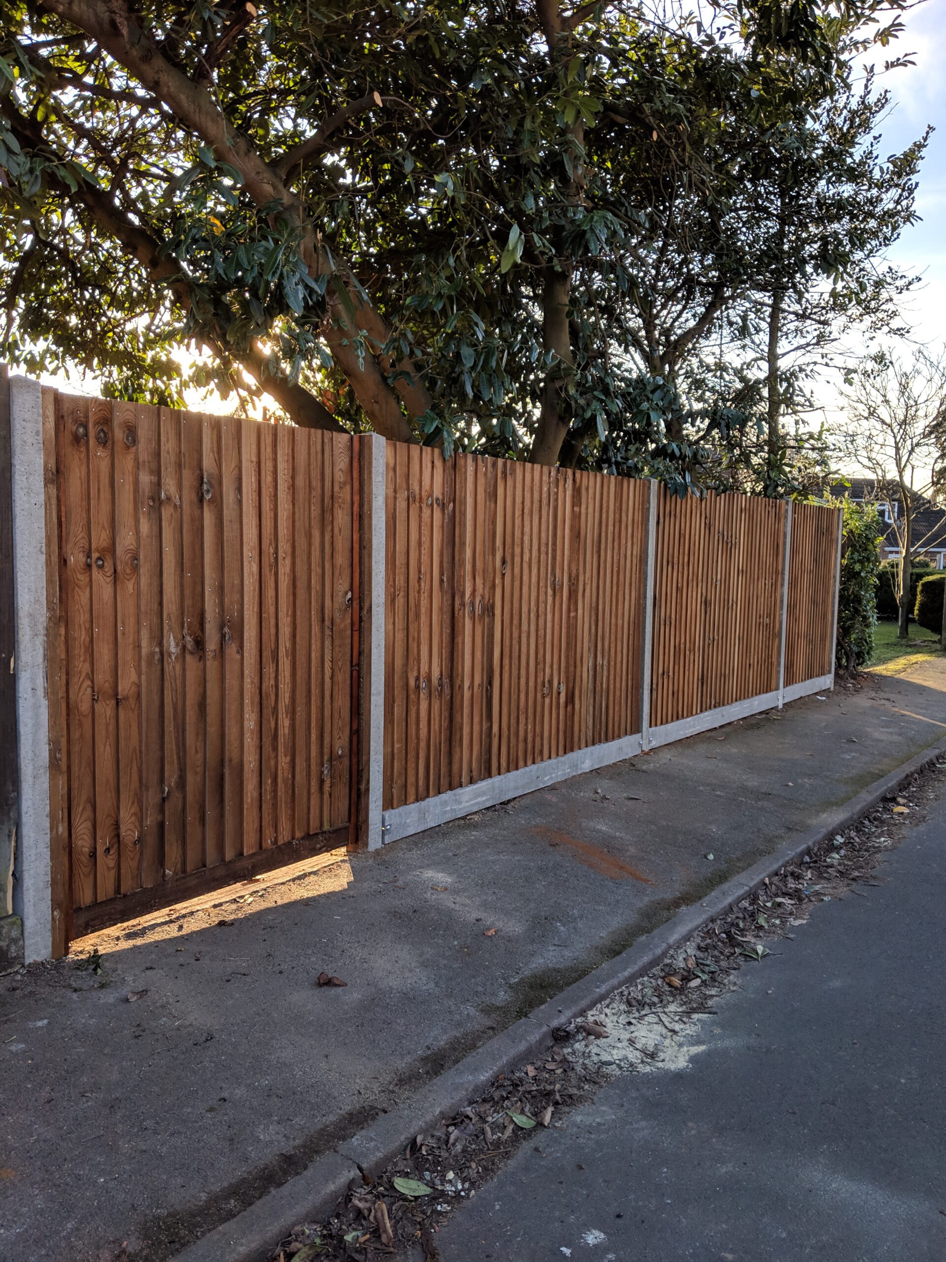 closeboard fencing with concrete gravelboards and posts with a custom size gate