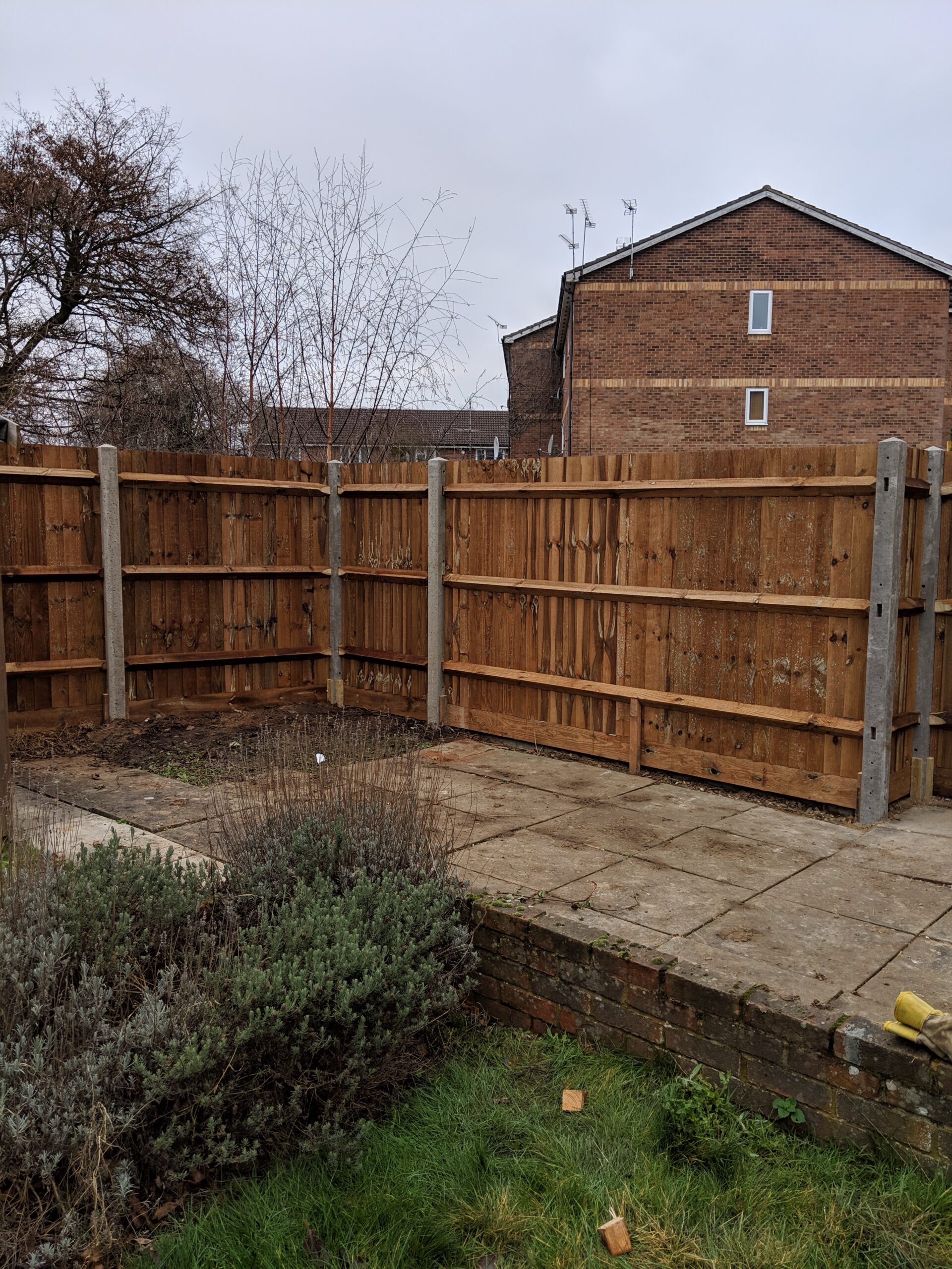 Back of closeboard fencing timber gravelboards and concrete posts